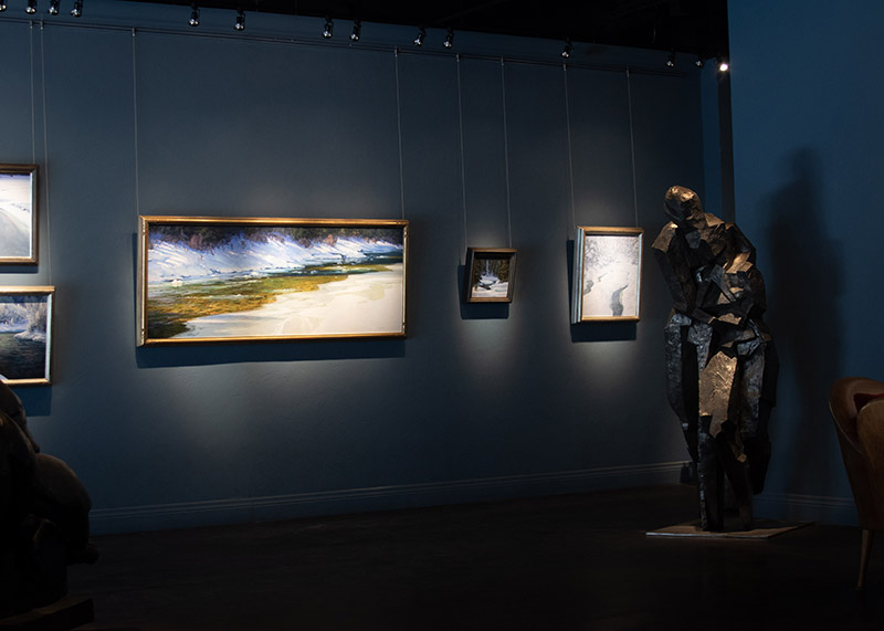 A series of paintings hung in the gallery.